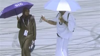 زوج يرش المياه على وجه زوجته في مشهد إنساني مؤثر بجبل عرفات خلال أداء مناسك الحج - الخليج الان